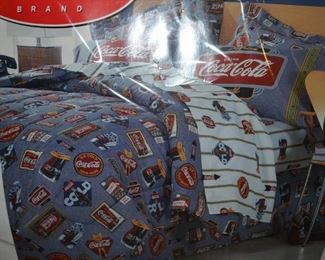 Complete Coca Cola sheet and comforter set for a full size bed.