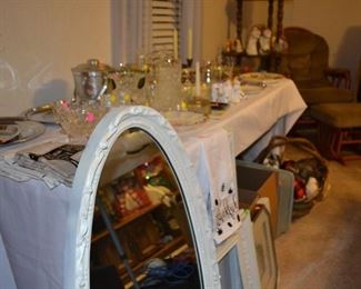 Table full of elegant serving/entertaining pieces, shabby chic mirror and frames. Hand made country kitchen towels.