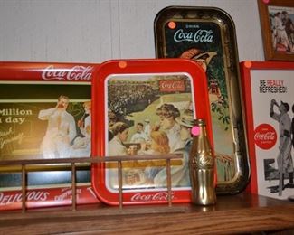 Many Coca Cola tin trays, clocks and alarm clocks.