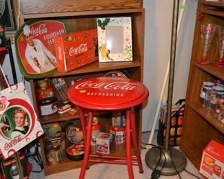 Lot's of Coca Cola glassware, holiday decorations,  three sets of Coca Cola Christmas tree lights and folding stool.