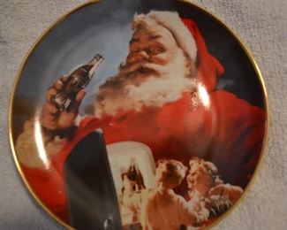 13 collector plates from Coca Cola Christmas plate series marketed by Franklin Mint.