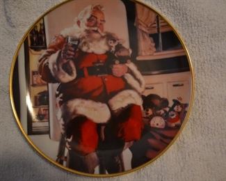 13 collector plates from Coca Cola Christmas plate series marketed by Franklin Mint.