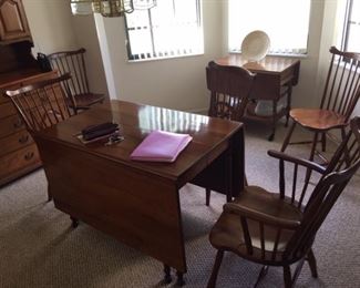 Stickley Cherry drop leaf dining table with matching two arm chairs and four chairs. Wine cart pictured in background