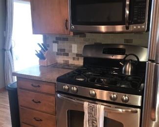 Kitchen cabinets, gas range, microwave