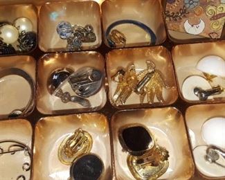 Variety of brooches and clip on earrings.