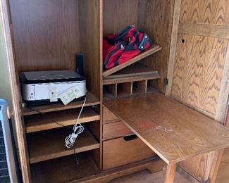 Armoire with built-in fold out sewing table