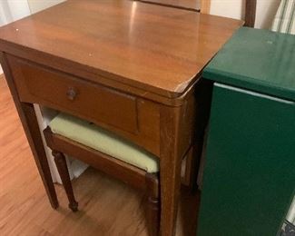 Vintage sewing machine in cabinet