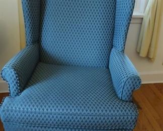 one  of  two  blue wing  back chairs