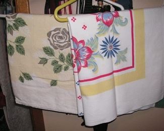 Two of several printed kitchen table cloths