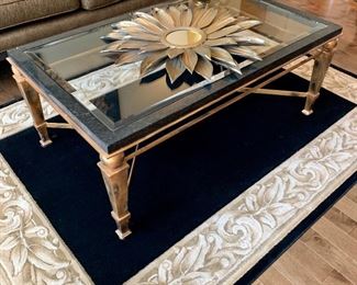 Heavy gilt and granite coffee table with beveled glass...measures 