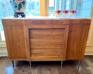 Beautiful marble top John Widdicomb Ash cabinet featuring tons of storage, a tambour door, and patina hardware in excellent vintage condition.   14"D x 48"W x 33"H