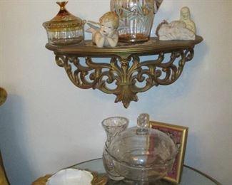 glass items on top of mermaid stand
