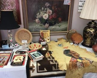 Oil on hide, portrait of Native American (right). Native American pottery, rug, antique Navajo wedding basket. Geometric rug (center) by Ina Begay; acquired at Shipwreck Trading Post, Shipwreck, NM, in very good condition. Rear right: Vintage Chinese lamp.