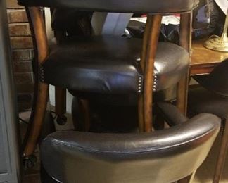 Set of 6 rolling chairs. A couple of them are missing the vinyl over the padded arms.