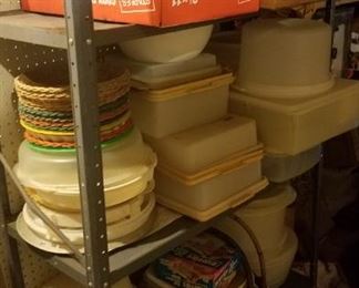 Shelves of Tupperware, housewares, paper plate holder baskets, cake storers and more!