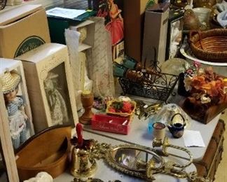 pprcelain dolls, lots of decor and brass art, and metal wall art.