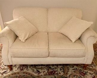 Cream chenille loveseats with exposed wood legs, Pair