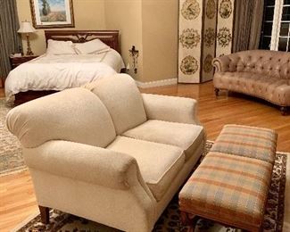 Cream chenille loveseat, two matching ottomans