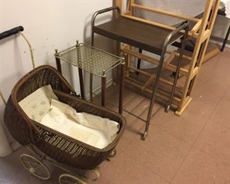 Assorted tables and shelves and vintage baby buggy.