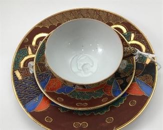 Beautiful tea cup, saucer and plate set with amazing detailed face in the bottom of the tea cup. China logo from Japan.