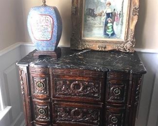 Antique four drawer carved chest with black marble top