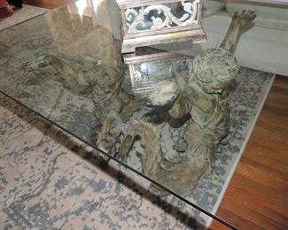 glass top coffee table with cast iron cherub base