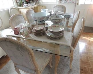 glass top whitewashed wood table with six fabric covered chairs