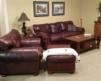 The den features a leather sleeper sofa and matching chair with ottoman.