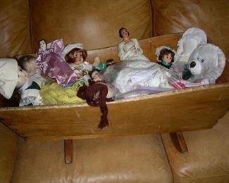Child's cradle with dolls and stuffed animals