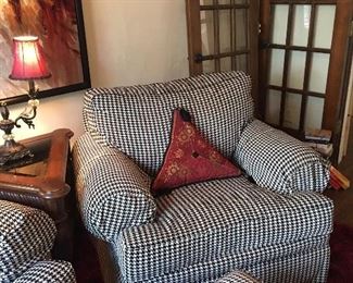 Pair of oversized herringbone chairs with ottoman; triangular wood and glass accent table, contemporary artwork, reading lamp; pair of red/black triangular pillows