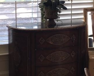 Bowed front chest;  floral arrangement