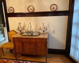 Louis XBI style commode, with marble top, three drawers, musical trophy marquetry inlay, circa 1900.