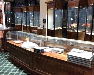 Notice the Tall Showcases behind the counter