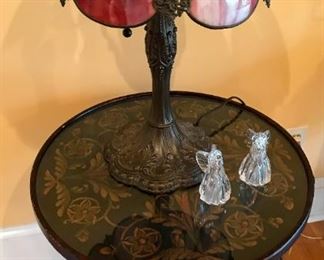 Detail on round table w/ glass top, closer view of  slag glass lamp with Tiffany style base, glass angels