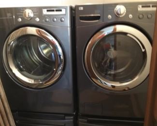 Elite top-of-line washer and dryer with risers, about a year old.