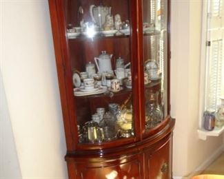 CORNER CHINA CABINET FULL OF STERLING SILVER AND TEA CUPS WITH SAUCERS 