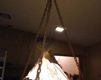 This is a hanging light/lamp. Real hide hanging from rustic style chains. Has horses that stand up on rim, it’s also a teepee tent!!! Wow!!