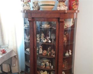 Beautiful curved glass antique cabinet.