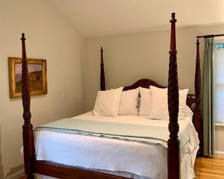 An elegantly designed Ethan Allen “Montego” plantation poster bed made of maple wood. The king-sized bed features four dramatic turned posts accented with carved pineapple detailing in a mahogany finish. It is a beautiful piece.