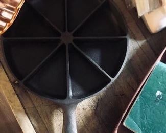 One of two old cast iron cornbread pans