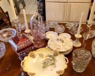 Table top shown with hand painted china, brilliant cut glass pieces and crystal candle sticks. 