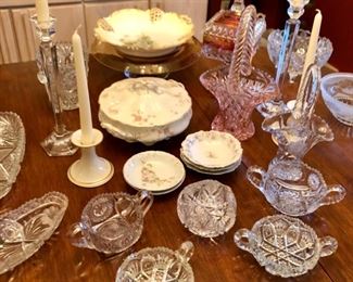Table top shown with hand painted china, brilliant cut glass pieces and crystal candle sticks. 