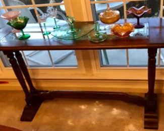 Antique Jacobean sofa table with carnival glass and green Victorian glass pieces.  