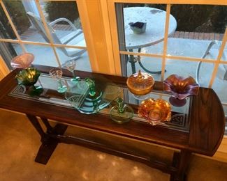 Antique Jacobean sofa table that has a etched glass top, with carnival glass and green Victorian glass pieces.  