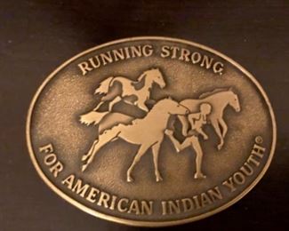 indian youth running with horses belt buckle