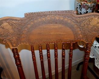 Antique rocking chair with carved wolves