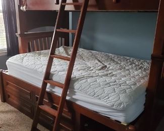 Twin and full size bunk bed. 4 drawers 2 handles missing. 2 shelves. Few scratches comes with ladder and mattresses