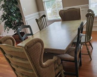 Beautiful country table with extra leaf. Its is painted with a floral design, green color very pretty. Few scratches. Comes with 6 chairs 3 different styles. 71x41 1/4 plus the extra leaf is an extra ft