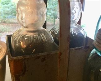Figural baby Milk bottles with carrier. I’ve never seen anything like these!