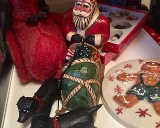 Two dogs pulling Santa Christmas carved figurines